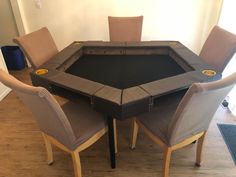 a dining room table with chairs around it and a black cloth top on the center