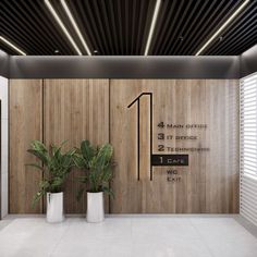 two planters in front of a wooden wall with the number 1 office on it