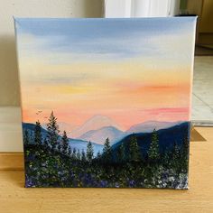 an acrylic painting of mountains and trees at sunset