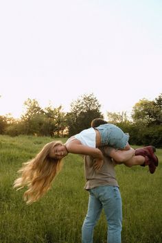 a man carrying a woman on his back in a field