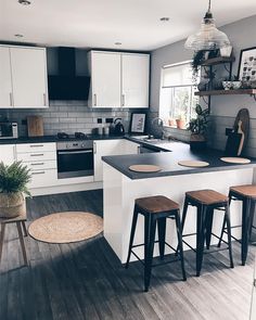 the kitchen is clean and ready to be used for cooking or eating, with stools around the island