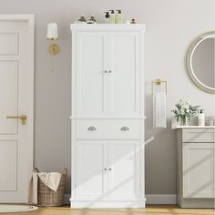 a white bathroom cabinet next to a door