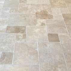 a white toilet sitting on top of a bathroom floor next to a tiled flooring