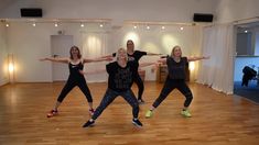 three women are standing in a dance class