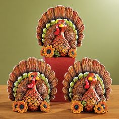 three turkey figurines sitting on top of a table