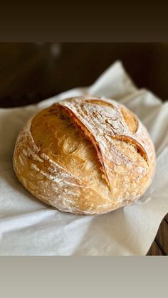 a loaf of bread sitting on top of a white napkin