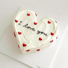 a heart shaped cake with the words i love you written on it