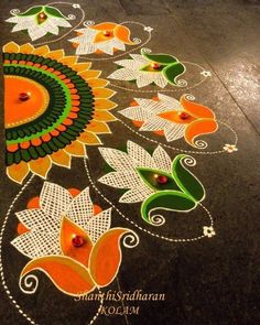 an artistic design on the ground for diwaling with flowers and leaves painted on it