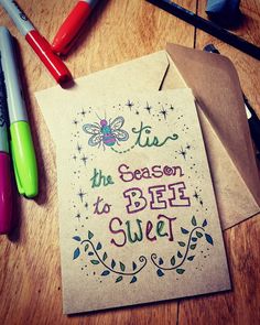 a card that says tis the season to bee sweet on it next to markers and pens