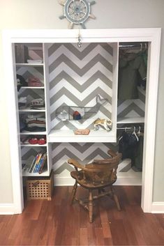 the closet is decorated with chevron gray and white wallpaper