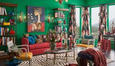 a living room filled with lots of furniture and windows covered in bright green curtains,