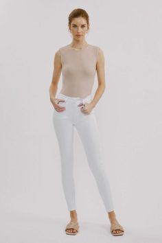 This White Skinny Jean is a closet must-have. It features a zipper front, as well as front and rear pockets for convenience. Constructed with comfort stretch denim, it offers a snug fit with just the right amount of give. The high rise waist helps to enhance the silhouette while the non-distressed finish provides a tim Jean Pants, Sweater Blouse, Skirt Pants, Bottoms Pants, Short Sets, Stretch Denim, Snug Fit, White Jeans, Sweater Top