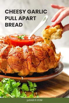 someone is dipping cheese on top of a pull apart bread with tomatoes and parsley