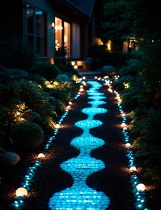 the pathway is lit up with blue lights and there are candles on each side of it