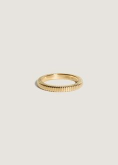 a yellow gold band ring on a white background