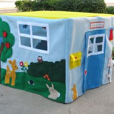 a child's play house with animals painted on it