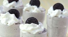 four dessert cups with oreo cookies and whipped cream