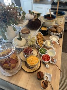 a wooden table topped with lots of food and condiments on top of it