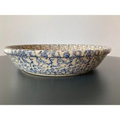 a blue and white bowl sitting on top of a table