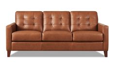 a brown leather couch sitting on top of a white floor