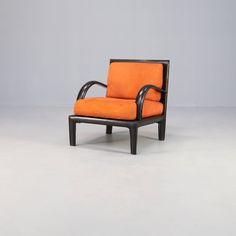 an orange chair sitting on top of a white floor