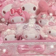 there are many stuffed animals in the pink suitcases with bows on their head and ears