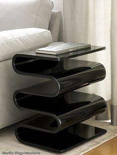 a black shelf sitting on top of a white couch