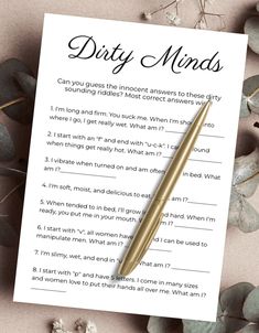 a dirty minds card with a pen on it next to some flowers and leaves in the background