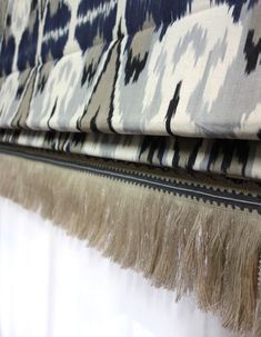 a close up view of a curtain with fringes on the bottom and side of it