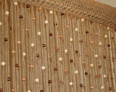 a close up of a curtain with beads on it