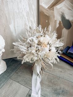 a bouquet of white flowers sitting on top of a table