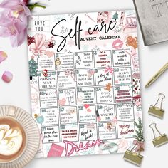 a calendar with the words self care on it next to some flowers and other items