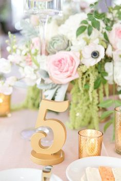 the table is set with flowers and candles