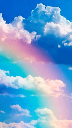 a rainbow in the sky with clouds