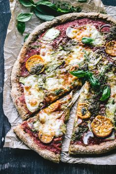 a pizza with several slices missing from it on top of a piece of wax paper