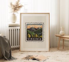 a framed photo sitting on top of a white rug next to a wooden table and radiator