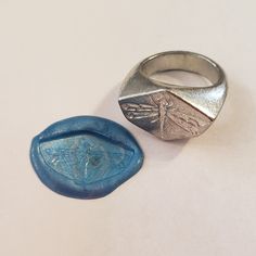 This signet ring is cast in lead-free pewter. The ring size when cast is 7.25. The sealing image is a dragonfly.       This is part of a series of signet rings I am making cast from lead-free pewter. Each master ring is hand sculpted to give a unique, rustic style, multi-dimensional relief image when used as a stamp to seal, with sealing wax.