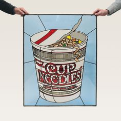 two hands holding a poster with a bowl of noodles in it