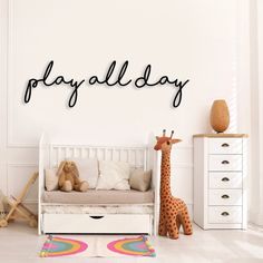 a child's room with a bed, toy and stuffed giraffe