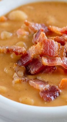 a white bowl filled with soup and bacon