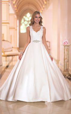 a woman in a white wedding dress posing for the camera