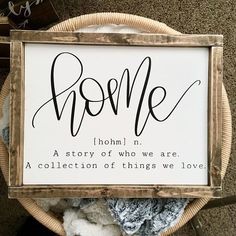 a wooden sign that says,'hom'n a story of who we are a collection of things we love '