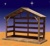 a nativity scene with a wooden stable and stars in the sky