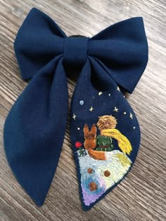 a blue bow tie with two dogs on it