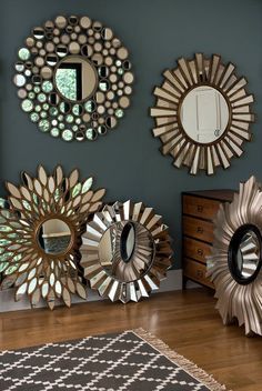 three mirrors on the wall above a dresser