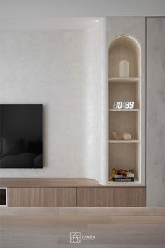 an empty living room with a large tv on the wall and shelves in front of it