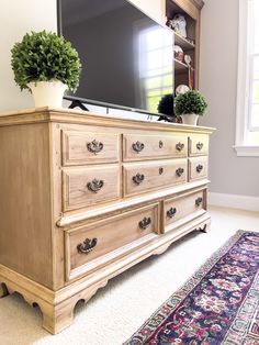 an old dresser is turned into a tv stand