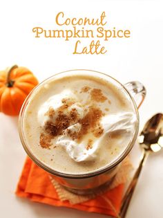 a pumpkin spice latte is garnished with whipped cream