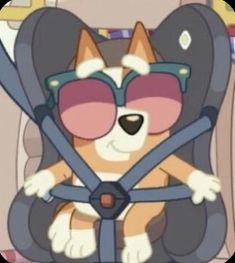 a cartoon cat wearing sunglasses and sitting in a car seat with the steering wheel down