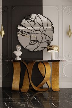 a black and gold console table with a round mirror above it on the wall behind it